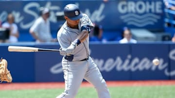 Jul 27, 2016; Toronto, Ontario, CAN; San Diego Padres catcher Christian Bethancourt (12) hits a double RBI in the sixth inning against the Toronto Blue Jays at Rogers Centre. Mandatory Credit: Kevin Sousa-USA TODAY Sports
