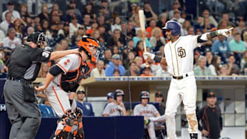 Jul 16, 2016; San Diego, CA, USA; San Diego Padres shortstop Alexei Ramirez (right) signals for a balk from homeplate umpire Dana DeMuth (32) during the tenth inning as San Francisco Giants catcher Buster Posey (center) looks on at Petco Park. The San Diego Padres win 7-6. Mandatory Credit: Jake Roth-USA TODAY Sports
