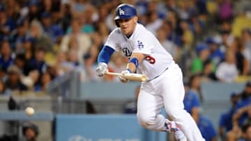 July 8, 2016; Los Angeles, CA, USA; Los Angeles Dodgers catcher Yasmani Grandal (9) lays down a bunt to reach first in the fourth inning against San Diego Padres at Dodger Stadium. Mandatory Credit: Gary A. Vasquez-USA TODAY Sports