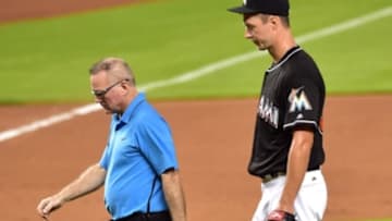 Jul 30, 2016; Miami, FL, USA; Miami Marlins starting pitcher Colin Rea (right) walks back to the dugout with a member of the medical staff after Rea injured his are during the fourth inning against the St. Louis Cardinals at Marlins Park. Mandatory Credit: Steve Mitchell-USA TODAY Sports