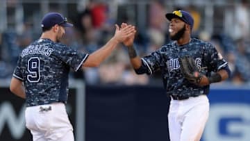 Sep 24, 2016; San Diego, CA, USA; San Diego Padres third baseman Adam Rosales (9) celebrates a 4-3 win over the San Francisco Giants with center fielder Manuel Margot (70) at Petco Park. Mandatory Credit: Jake Roth-USA TODAY Sports