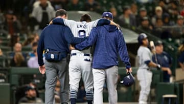 SEATTLE, WA - SEPTEMBER 11: Luis Urias #9 of the San Diego Padres is helped off the field by a trainer and San Diego Padres manager Andy Green after apparently injuring his leg eighth inning at Safeco Field on September 11, 2018 in Seattle, Washington. (Photo by Lindsey Wasson/Getty Images)