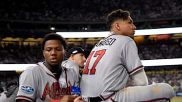 LOS ANGELES, CA - OCTOBER 05: Ronald Acuna Jr. #13 and Johan Camargo #17 of the Atlanta Braves reacts during the eighth inning against the Los Angeles Dodgers during Game Two of the National League Division Series at Dodger Stadium on October 5, 2018 in Los Angeles, California. The Los Angeles Dodgers defeated the Atlanta Braves 3-0. (Photo by Kevork Djansezian/Getty Images)