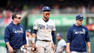 WASHINGTON, DC - APRIL 28: Fernando Tatis Jr. #23 of the San Diego Padres walks off the field with head athletic trainer Mark Rogow and manager Andy Green #14 after being injured in the 10th inning against the Washington Nationals at Nationals Park on April 28, 2019 in Washington, DC. (Photo by Greg Fiume/Getty Images)