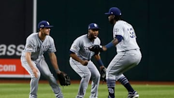 PHOENIX, AZ - APRIL 12: (L to R) Wil Myers #4, Manuel Margot #7 and Franmil Reyes #32 of the San Diego Padres celebrate following a 2-1 victory against the Arizona Diamondbacks during an MLB game at Chase Field on April 12, 2019 in Phoenix, Arizona. (Photo by Ralph Freso/Getty Images)