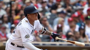 SAN DIEGO, CA - JUNE 5: Manny Machado #13 of the San Diego Padres hits a double during the third inning of a baseball game against the Philadelphia Phillies at Petco Park June 5, 2019 in San Diego, California. (Photo by Denis Poroy/Getty Images)