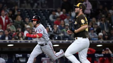 SAN DIEGO, CA - JUNE 7: Brian Dozier #9 of the Washington Nationals scores as Adam Warren #17 of the San Diego Padres looks on during the ninth inning of a baseball game at Petco Park June 7, 2019 in San Diego, California. (Photo by Denis Poroy/Getty Images)