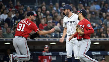 SAN DIEGO, CA - JUNE 8: Eric Hosmer #30 of the San Diego Padres is tagged out by Max Scherzer #31 of the Washington Nationals as Anthony Rendon #6 looks on during the second inning of a baseball game at Petco Park June 8, 2019 in San Diego, California. Hosmer was caught off third base. (Photo by Denis Poroy/Getty Images)
