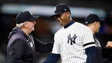 NEW YORK, NEW YORK - MAY 15: Pitching coach Larry Rothschild #58 of the New York Yankees congratulates closing pitcher Aroldis Chapman #54 after the Yankees win 3-1 during game two of a double header against the Baltimore Orioles at Yankee Stadium on May 15, 2019 in the Bronx borough of New York City. (Photo by Sarah Stier/Getty Images)