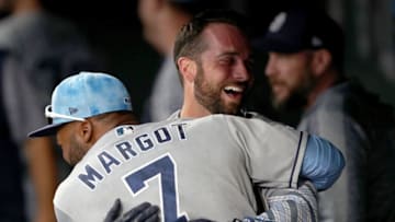 DENVER, COLORADO - JUNE 16: Greg Garcia #5 of the San Diego Padres celebrates in the dugout with Manuel Margot #7 after scoring against the Colorado Rockies in the ninth inning against the Colorado Rockies at Coors Field on June 16, 2019 in Denver, Colorado. (Photo by Matthew Stockman/Getty Images)