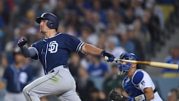 LOS ANGELES, CALIFORNIA - JULY 05: Hunter Renfroe #10 of the San Diego Padres hits a solo homerun, in front of Austin Barnes #15 of the Los Angeles Dodgers, to take a 3-2 lead, during the eighth inning at Dodger Stadium on July 05, 2019 in Los Angeles, California. (Photo by Harry How/Getty Images)