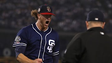 LOS ANGELES, CALIFORNIA - JULY 06: Pitcher Chris Paddack #59 of the San Diego Padres reacts after getting the force out at first base with the bases loaded to end the fifth inning of the MLB game against the Los Angeles Dodgers during the MLB game at Dodger Stadium on July 06, 2019 in Los Angeles, California. (Photo by Victor Decolongon/Getty Images)