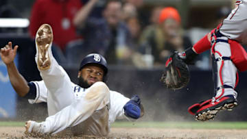 SAN DIEGO, CALIFORNIA - JULY 13: Manuel Margot #7 scores from third bast as Fernando Tatis Jr. #23 of the San Diego Padres steals second base as Tyler Flowers #25 of the Atlanta Braves attempst to apply the tag during the seventh inning of a game at PETCO Park on July 13, 2019 in San Diego, California. (Photo by Sean M. Haffey/Getty Images)