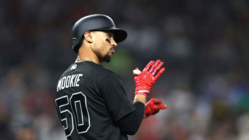 SAN DIEGO, CALIFORNIA - AUGUST 23: Mookie Betts #50 of the Boston Red Sox reacts after hitting an RBI sacrifice fly during the second inning of a game against the San Diego Padres at PETCO Park on August 23, 2019 in San Diego, California. Teams are wearing special color schemed uniforms with players choosing nicknames to display for Players' Weekend. (Photo by Sean M. Haffey/Getty Images)