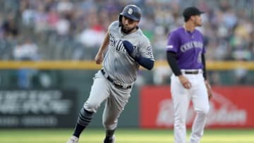 DENVER, COLORADO - SEPTEMBER 14: Eric Hosmer #30 of the San Diego Padres scores on a Will Myers double in the first inning against the Colorado Rockies at Coors Field on September 14, 2019 in Denver, Colorado. (Photo by Matthew Stockman/Getty Images)