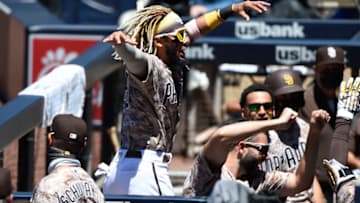 SAN DIEGO, CA - AUGUST 9: Fernando Tatis Jr. #23 of the San Diego Padres celebrates in the dugout after Manny Machado #13 hit a solo home run during the first inning of a baseball game against the Arizona Diamondbacks at Petco Park on August 9, 2020 in San Diego, California. (Photo by Denis Poroy/Getty Images)