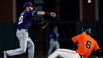 SAN FRANCISCO, CA - SEPTEMBER 29: Carlos Asuaje #20 of the San Diego Padres completes a double play over Jarrett Parker #6 of the San Francisco Giants during the fifth inning at AT&T Park on September 29, 2017 in San Francisco, California. The San Francisco Giants defeated the San Diego Padres 8-0. (Photo by Jason O. Watson/Getty Images)