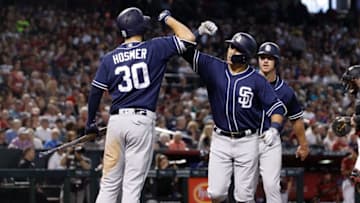 PHOENIX, AZ - APRIL 22: Christian Villanueva #22 of the San Diego Padres is congratulated by teammate Eric Hosmer #30 after hitting a two-run home run against the Arizona Diamondbacks during the sixth inning of an MLB game at Chase Field on April 22, 2018 in Phoenix, Arizona. (Photo by Ralph Freso/Getty Images)