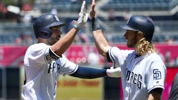 SAN DIEGO, CA - MAY 15: Eric Hosmer #30 of the San Diego Padres, left, is congratulated by Travis Jankowski #16 after hitting a two-run home run during the first inning of a baseball game against the Colorado Rockies at PETCO Park on May 15, 2018 in San Diego, California. (Photo by Denis Poroy/Getty Images)