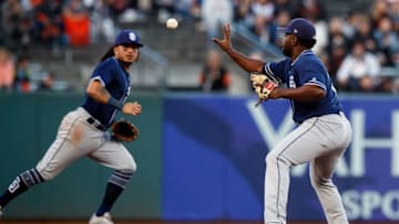 SAN FRANCISCO, CA - JUNE 21: Freddy Galvis #13 of the San Diego Padres tosses the ball to Jose Pirela #2 of the San Diego Padres to turn a double play against the San Francisco Giants during the first inning at AT&T Park on June 21, 2018 in San Francisco, California. (Photo by Jason O. Watson/Getty Images)