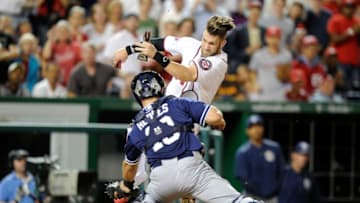 WASHINGTON, DC - AUGUST 27: Bryce Harper #34 of the Washington Nationals is tagged out at home plate in the fifth inning by Austin Hedges #18 of the San Diego Padres at Nationals Park on August 27, 2015 in Washington, DC. (Photo by Greg Fiume/Getty Images)