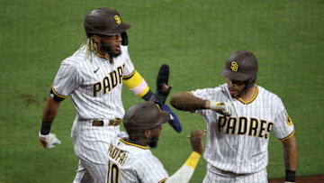 SAN DIEGO, CALIFORNIA - JULY 24: Fernando Tatis Jr. #23, Jurickson Profar #10 and Tommy Pham #28 react after scoring on a double hit by Eric Hosmer #30 of the San Diego Padres during the sixtyh inning of the Opening Day game against the Arizona Diamondbacks at PETCO Park on July 24, 2020 in San Diego, California. (Photo by Sean M. Haffey/Getty Images)