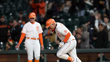 SAN FRANCISCO, CALIFORNIA - APRIL 12: Joc Pederson #23 of the San Francisco Giants reacts as passes first base coach Alyssa Nakken after he hit a home run in the eighth inning against the San Diego Padres at Oracle Park on April 12, 2022 in San Francisco, California. (Photo by Ezra Shaw/Getty Images)