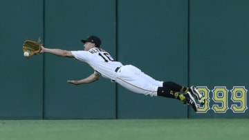 Jun 8, 2021; Pittsburgh, Pennsylvania, USA; Pittsburgh Pirates center fielder Bryan Reynolds (10) dives for but can not catch a ball hit for an RBI double by Los Angeles Dodgers left fielder AJ Pollock (not pictured) during the fifth inning at PNC Park. Mandatory Credit: Charles LeClaire-USA TODAY Sports