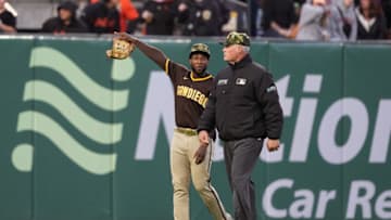May 20, 2022; San Francisco, California, USA; San Diego Padres left fielder Jurickson Profar (10) talks to second base umpire Ted Barrett (65) after baseballs were thrown onto the field during the third inning against the San Francisco Giants at Oracle Park. Mandatory Credit: Darren Yamashita-USA TODAY Sports