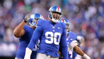 Dec 20, 2015; East Rutherford, NJ, USA; New York Giants defensive end Jason Pierre-Paul (90) reacts after blocking a pass by Carolina Panthers quarterback Cam Newton (not pictured) during the fourth quarter at MetLife Stadium. The Panthers defeated the Giants 38-35. Mandatory Credit: Brad Penner-USA TODAY Sports