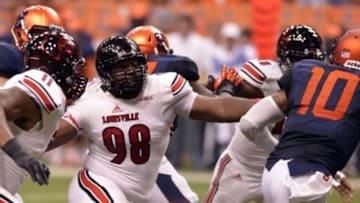 Oct 3, 2014; Syracuse, NY, USA; Louisville Cardinals defensive end Sheldon Rankins (98) chases Syracuse Orange quarterback Terrel Hunt (10) during the fourth quarter of a game at the Carrier Dome. Louisville won the game 28-6. Mandatory Credit: Mark Konezny-USA TODAY Sports