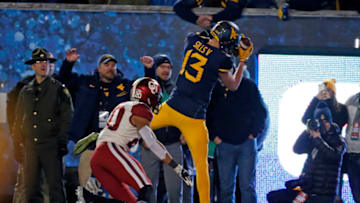 MORGANTOWN, WV - NOVEMBER 23: David Sills V #13 of the West Virginia Mountaineers catches a 10 yard touchdown pass in the first half against Robert Barnes #20 of the Oklahoma Sooners on November 23, 2018 at Mountaineer Field in Morgantown, West Virginia. (Photo by Justin K. Aller/Getty Images)