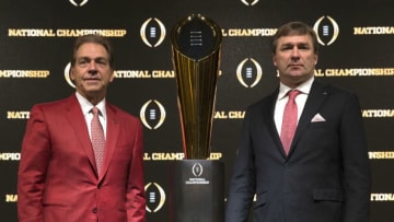 ATLANTA, GA - JANUARY 07: University of Alabama head coach Nick Saban (left) and University of Georgia head coach Kirby Smart stand with the College Football Playoff National Championship trophy after a Coaches Press Conference on January 7, 2018 in Atlanta, Georgia. (Photo by Mike Zarrilli/Getty Images)