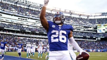 EAST RUTHERFORD, NEW JERSEY - DECEMBER 15: Saquon Barkley #26 of the New York Giants celebrates his touchdown in the fourth quarter against the Miami Dolphins at MetLife Stadium on December 15, 2019 in East Rutherford, New Jersey.The New York Giants defeated the Miami Dolphins 31-13. (Photo by Elsa/Getty Images)
