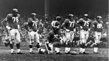 American professional football players and members of the New York Giants defensive line including Rosey Grier (#76), Sam Huff (#70), and Roosevelt 'Rosey' Brown (#79) (1932 - 2004) wait on the field during a game, late 1950s or early 1960s. (Photo by Robert Riger/Getty Images)