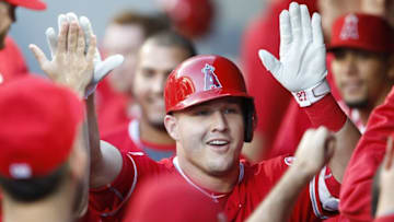 Sep 3, 2016; Seattle, WA, USA; Los Angeles Angels center fielder Mike Trout (27) is greeted in the dugout after hitting a solo-home run against the Seattle Mariners during the first inning at Safeco Field. Mandatory Credit: Joe Nicholson-USA TODAY Sports