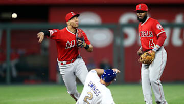 KANSAS CITY, MISSOURI - APRIL 26: Shortstop Andrelton Simmons #2 of the Los Angeles Angels throws toward first for a double play as Chris Owings #2 of the Kansas City Royals slides into second during the game at Kauffman Stadium on April 26, 2019 in Kansas City, Missouri. (Photo by Jamie Squire/Getty Images)