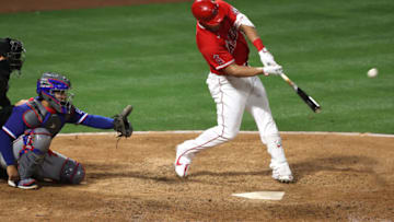 ANAHEIM, CALIFORNIA - APRIL 20: Mike Trout #27 of the Los Angeles Angels connects for a solo homerun as Jose Trevino #23 of the Texas Rangers looks on during the sixth inning of a game at Angel Stadium of Anaheim on April 20, 2021 in Anaheim, California. (Photo by Sean M. Haffey/Getty Images)