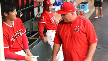 ANAHEIM, CA - JULY 27: Shohei Ohtani #17 talks with manager Mike Scioscia #14 of the Los Angeles Angels of Anaheim before the start of the game against the Seattle Mariners at Angel Stadium on July 27, 2018 in Anaheim, California. (Photo by Jayne Kamin-Oncea/Getty Images)