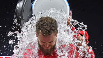 ANAHEIM, CA - MAY 25: Jared Walsh #25 of the Los Angeles Angels of Anaheim gets a celebratory ice water bath from Mike Trout #27 of the Los Angeles Angels of Anaheim after hitting a walk off single in the ninth inning of the game against the Texas Rangers at Angel Stadium of Anaheim on May 25, 2019 in Anaheim, California. (Photo by Jayne Kamin-Oncea/Getty Images)