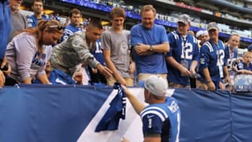 Sep 28, 2014; Indianapolis, IN, USA; Indianapolis Colts punter Pat McAfee (1) signs a jersey and gives it to a member of the United States Military after the game against the Tennessee Titans at Lucas Oil Stadium. The Colts defeated the Titans 41-17. Mandatory Credit: Pat Lovell-USA TODAY Sports