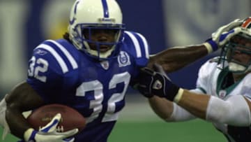 Running back Edgerrin James #32 of the Indianapolis Colts stiff arms linebacker Zach Thomas #54 of the Miami Dolphins during their game on September 15, 2002 at the RCA Dome in Indianapolis, Indiana. The Dolphins defeated the Colts 21-13.September 15, 2002| Credit: Jonathan Daniel