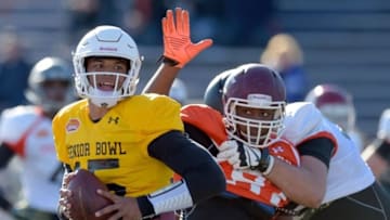Jan 28, 2016; Mobile, AL, USA; South squad quarterback Dak Prescott of Mississippi State (15) avoids the pressure of defensive end Noah Spence of Eastern Kentucky (97) during Senior Bowl practice at Ladd-Peebles Stadium. Mandatory Credit: Glenn Andrews-USA TODAY Sports