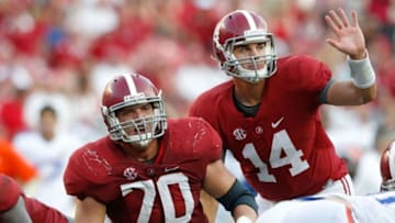 Sep 20, 2014; Tuscaloosa, AL, USA; Alabama Crimson Tide quarterback Jacob Coker (14) makes a call as Alabama Crimson Tide offensive lineman Ryan Kelly (70) looks up against the Florida Gators at Bryant-Denny Stadium. Mandatory Credit: Marvin Gentry-USA TODAY Sports