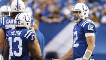 Oct 25, 2015; Indianapolis, IN, USA; Indianapolis Colts quarterback Andrew Luck (12) high fives wide receiver T.Y. Hilton (13) when he comes back to the huddle during a game against the New Orleans Saints at Lucas Oil Stadium. New Orleans defeats Indianapolis 27-21. Mandatory Credit: Brian Spurlock-USA TODAY Sports