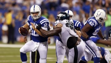 Aug 27, 2016; Indianapolis, IN, USA; Indianapolis Colts quarterback Andrew Luck (12) is tackled by Philadelphia Eagles defensive tackle Bennie Logan (96) at Lucas Oil Stadium. Mandatory Credit: Brian Spurlock-USA TODAY Sports