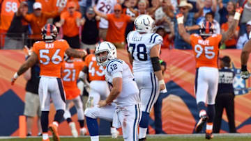 Sep 18, 2016; Denver, CO, USA; Indianapolis Colts quarterback Andrew Luck (12) reacts after throwing a interception to Denver Broncos cornerback Aqib Talib (21) (foreground) in the second half at Sports Authority Field at Mile High.The Broncos defeated the Colts 34-20. Mandatory Credit: Ron Chenoy-USA TODAY Sports