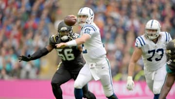 Oct 2, 2016; London, United Kingdom; Indianapolis Colts quarterback Andrew Luck (12) is pressured by Jacksonville Jaguars defensive end Dante Fowler (56) during game 15 of the NFL International Series at Wembley Stadium. Mandatory Credit: Kirby Lee-USA TODAY Sports