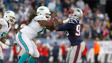 Dec 14, 2014; Foxborough, MA, USA; Miami Dolphins offensive tackle Dallas Thomas (63) blocks New England Patriots defensive end Chandler Jones (95) during the fourth quarter at Gillette Stadium. New England defeated Miami 41-13. Mandatory Credit: Stew Milne-USA TODAY Sports