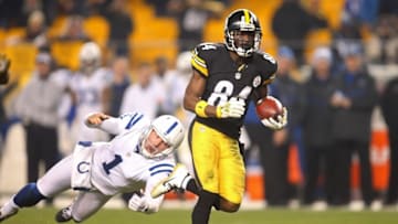 Dec 6, 2015; Pittsburgh, PA, USA; Pittsburgh Steelers wide receiver Antonio Brown (84) runs past Indianapolis Colts punter Pat McAfee (1) to score on a seventy-one yard punt return for a touchdown during the fourth quarter at Heinz Field. The Steelers won 45-10. Mandatory Credit: Charles LeClaire-USA TODAY Sports